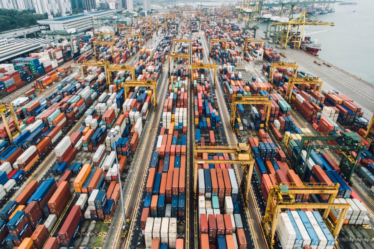 Container stacks, handling cranes and freight lanes at a Singapore cargo terminal. Photograph by CHUTTERSNAP.